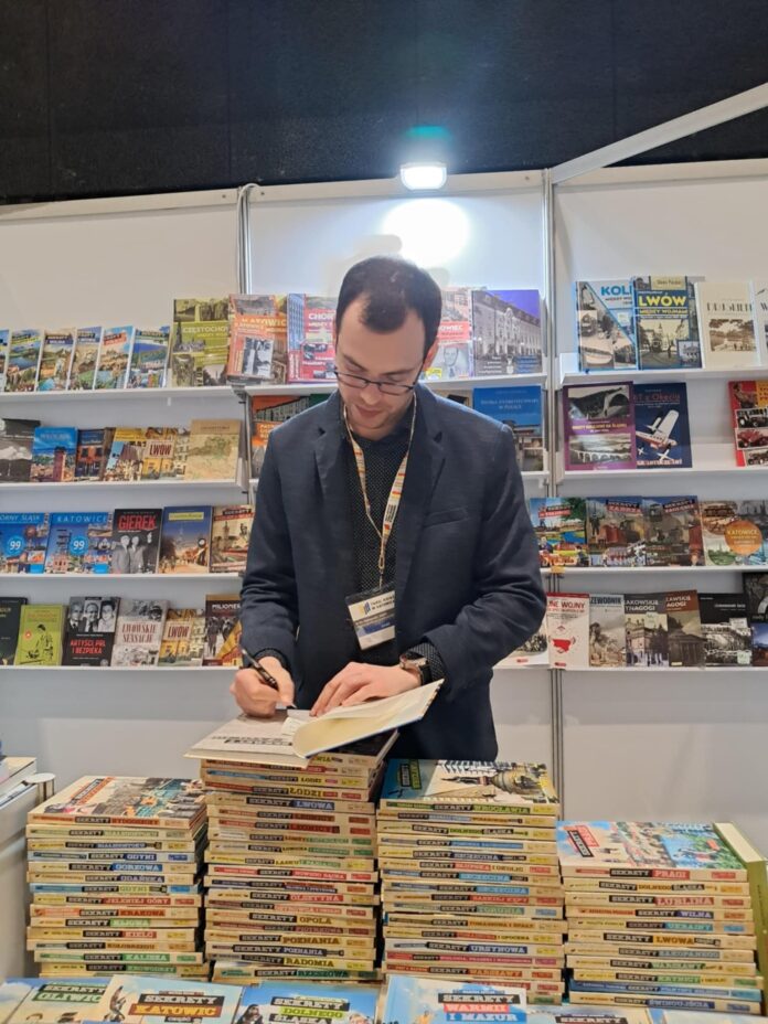 Mężczyzna podpisujący książki