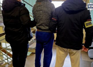 Kradł kawę i alkohol w Katowicach. 38-latek z 28 zarzutami i sprawą o narkotyki Zatrzymany mężczyzna prowadzony przez dwóch policjantów